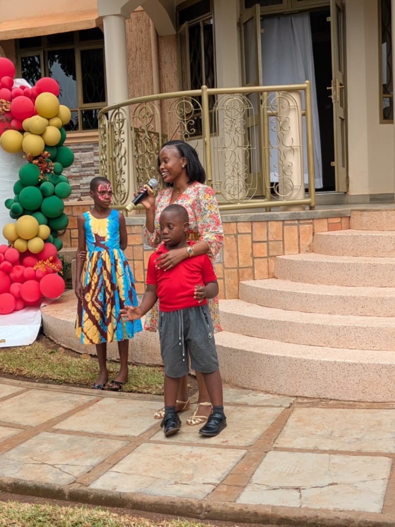 A speaker with children during a community program gathering.
