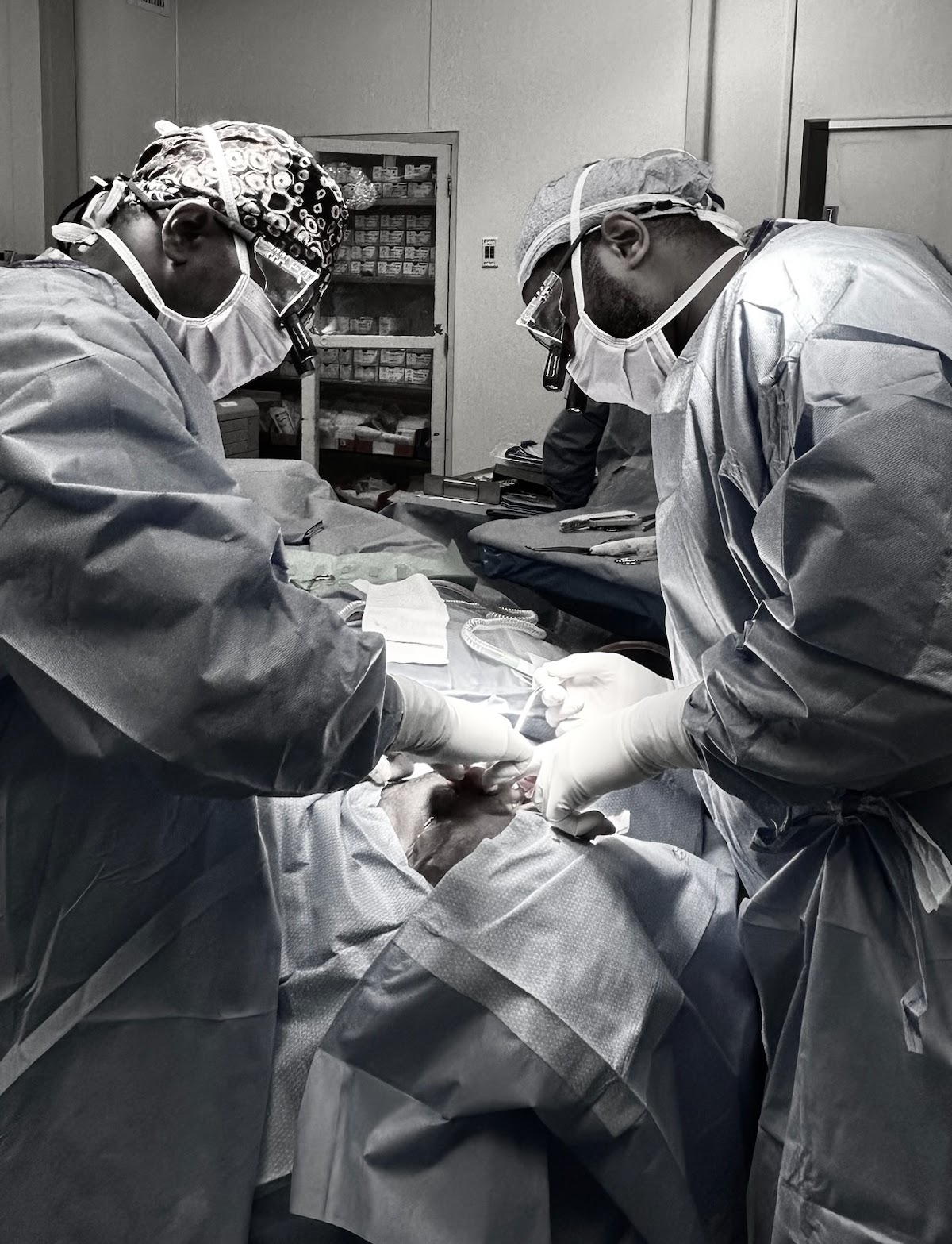 Surgeons operating together in a hospital operating room.