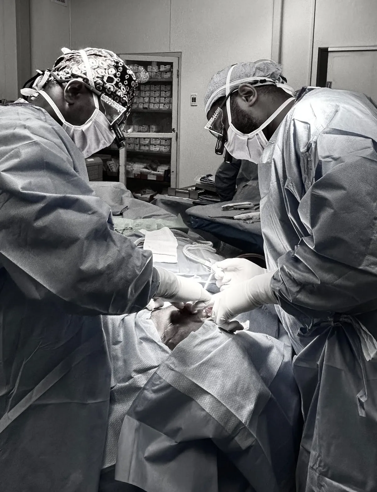 Surgeons operating together in a hospital operating room.